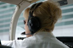 female private chief pilot in cockpit