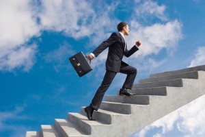 Business man climbing stairs in sky