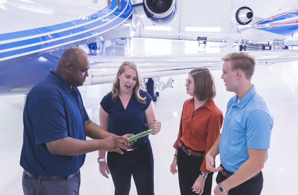 Diversity, equity and inclusion (DEI) - people standing next to business jet