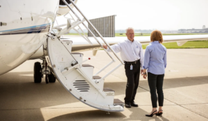 man and woman stand in front of corporate jet - retiring commercial airline pilots