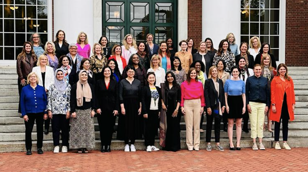Group of more than 40 diverse women standing in front of Harvard Business School - graduates of IWF Fellows Program