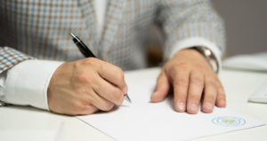 man signing training contract
