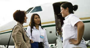 Three women in front of business jet - article about assumptions in business aviation