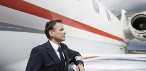 Airline hiring binge - captain standing by aircraft wing - Credit: Bernd Vogel/Getty Images