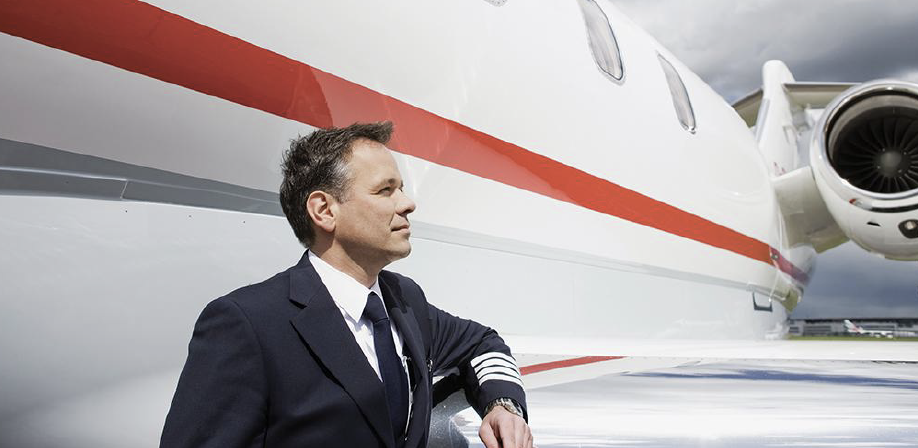 Airline captain standing by aircraft wing - Credit: Bernd Vogel/Getty Images