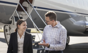 Reverse mentorship - image of woman and man talking in front of jet stairs on tarmac