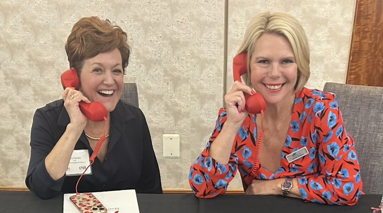 API's CEO Sheryl Barden and President Jennifer Pickerel holding red phones signifying Aviation Personnel International is on call to handle workforce questions