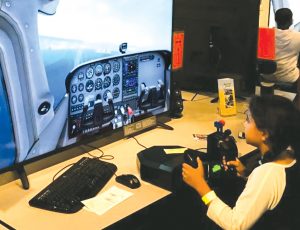 pilot shortage - Photo credit: Hiller Aviation Museum - photo of young girl flying plane simulator