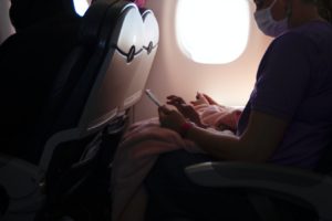 passenger on airline with COVID mask - AINsights blog by Sheryl Barden