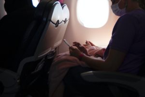 passenger on airline with COVID mask - AINsights blog by Sheryl Barden