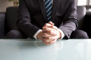 aviation outplacement services - man with hands clasped