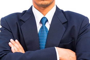 seven silent saboteurs business man in suit with arms crossed